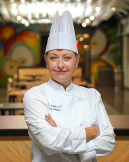 Woman wearing chef coat and hat